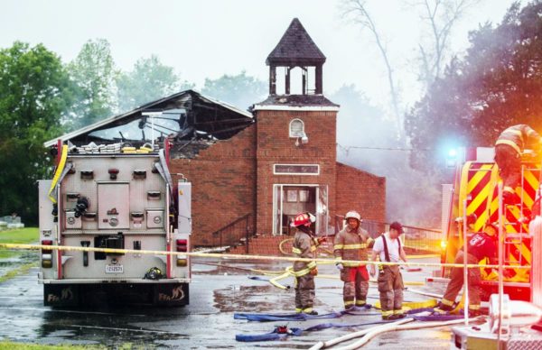 Leslie Westbrook/The Advocate via A. Caption: Firefighters and fire investigators respond to a fire at Mount Pleasant Baptist Church on April 4 in Opelousas, La.