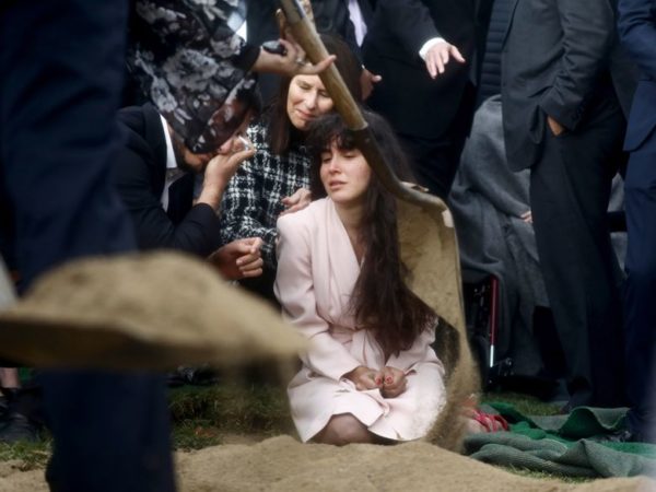 Photo: Mario Tama/Getty Images Caption: Hannah Kaye, daughter of shooting victim Lori Gilbert Kaye, mourns at her mother's grave during a graveside service on April 29, 2019, in San Diego, Calif. Kaye was killed inside the Chabad of Poway synagogue on April 27 by a gunman who opened fire as worshippers attended services.