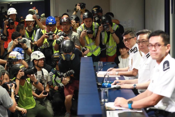 Photo: Yuen ChanCaption: Hong Kong press show up to police press conference in protective clothing and helmets to protest police brutality to journalists on June 13, 2019.