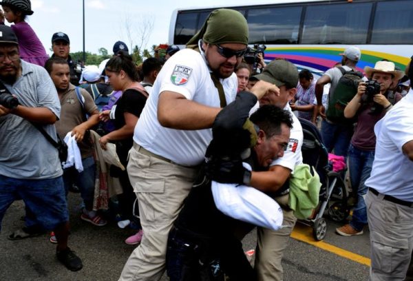 Reuters / Wednesday, June 05, 2019 Personnel of the National Immigration Institute (INM) detain a migrant during a joint operation by the Mexican government to stop a caravan of Central American migrants on their way to the U.S., at Metapa de Dominguez, in Chiapas state, Mexico June 5. REUTERS/Jose Torres