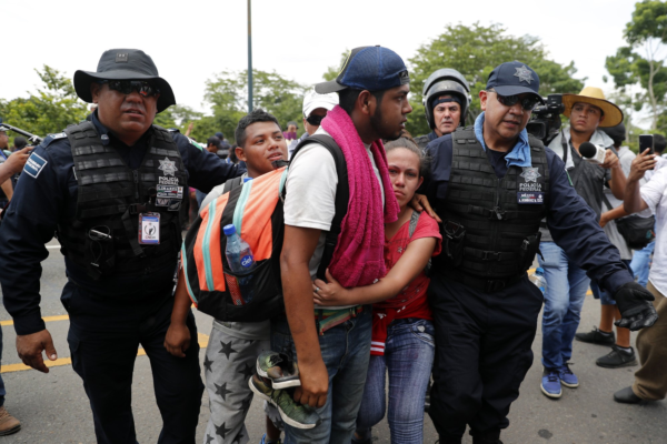 Migrants are detained by Mexican immigration authorities during a raid on a migrant caravan that had earlier crossed the Mexico - Guatemala border, near Metapa, Chiapas state, Mexico, Wednesday, June 5, 2019. (AP Photo/Marco Ugarte)