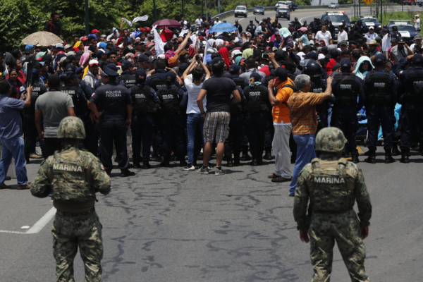 Mexican authorities stop a migrant caravan that had earlier crossed the Mexico - Guatemala border, near Metapa, Chiapas state, Mexico, Wednesday, June 5, 2019. (AP Photo/Marco Ugarte)