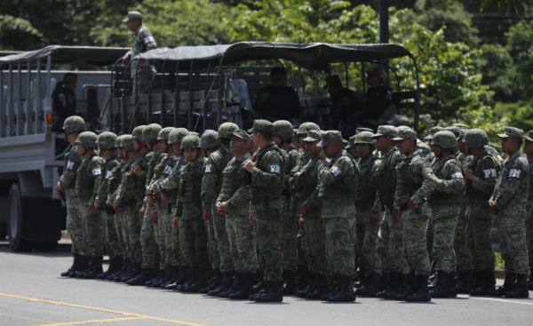 Military Police form up on the highway, in Metapa, Chiapas state Mexico, Wednesday, June 5, 2019. A law enforcement group of police officers, Marines, Military Police and immigration officials arrived at the area to intercept a caravan of migrants that had earlier crossed the Mexico – Guatemala border. (AP Photo/Marco Ugarte)