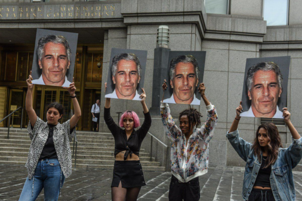 Photo: Stephanie Keith/Getty Images Caption: A protest group called "Hot Mess" hold up signs of Jeffrey Epstein in front of the Federal courthouse on July 8, 2019 in New York City. According to reports, Epstein will be charged with one count of sex trafficking of minors and one count of conspiracy to engage in sex trafficking of minors.