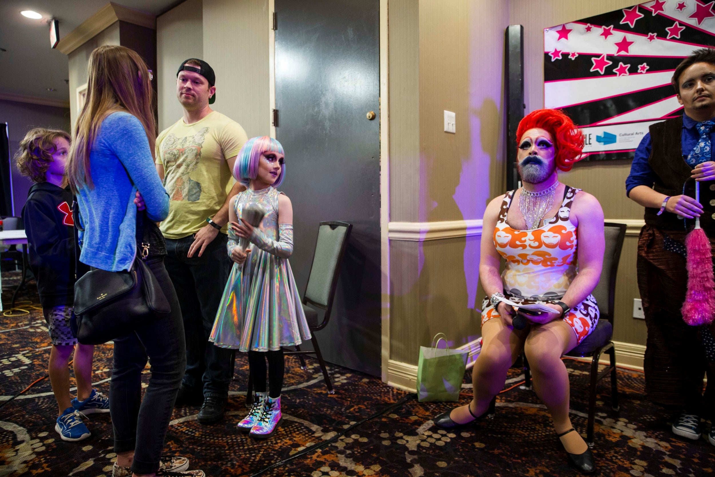 Photo: Amanda Voisard/Reuters. Keegan, accompanied by his family, glances at another performer during the Austin International Drag Festival 2018. 