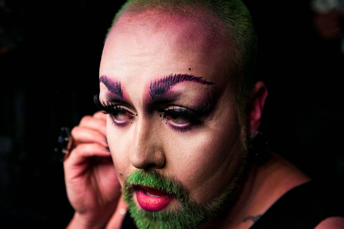 Photo: Amanda Voisard/Reuters. Robby prepares to take the stage during the International Drag Festival 2018. 