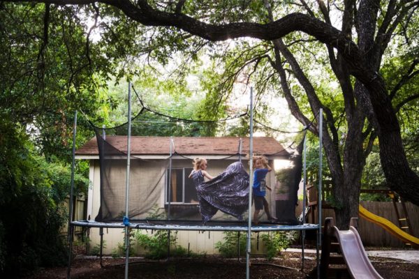 Photo: Amanda Voisard/Reuters. Keegan bounces on the trampoline with his brother Noah.