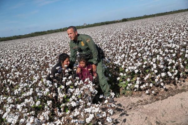 U.S. Border Patrol agent Carlos Ruiz apprehends a mother and daughter from Ecuador on September 10, 2019 in Penitas, Texas. The undocumented immigrants had been hiding for hours in a cotton field after border agents detected and chased their group earlier in the day. (Photo by John Moore/Getty Images)