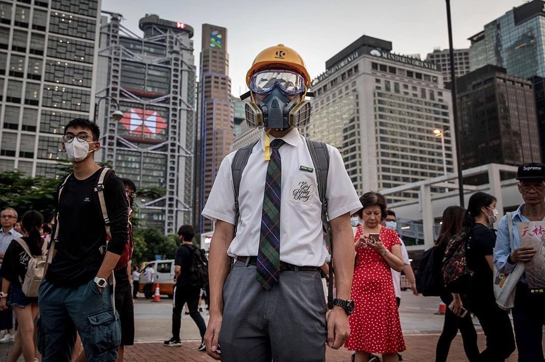 Photo: Chris McGrath/ Getty Images Caption: A student wears protective equipment with his school uniform during an anti- government student rally on August 22, 2019.