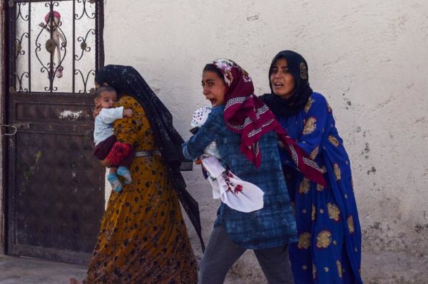 Photo: Ismail Coskun (IHA) via REUTERS Caption: Women run out of their home after a rocket fired from Syria landed in their neighborhood in the Turkish border town of Akcakale in Sanliurfa province, Turkey, October 10.