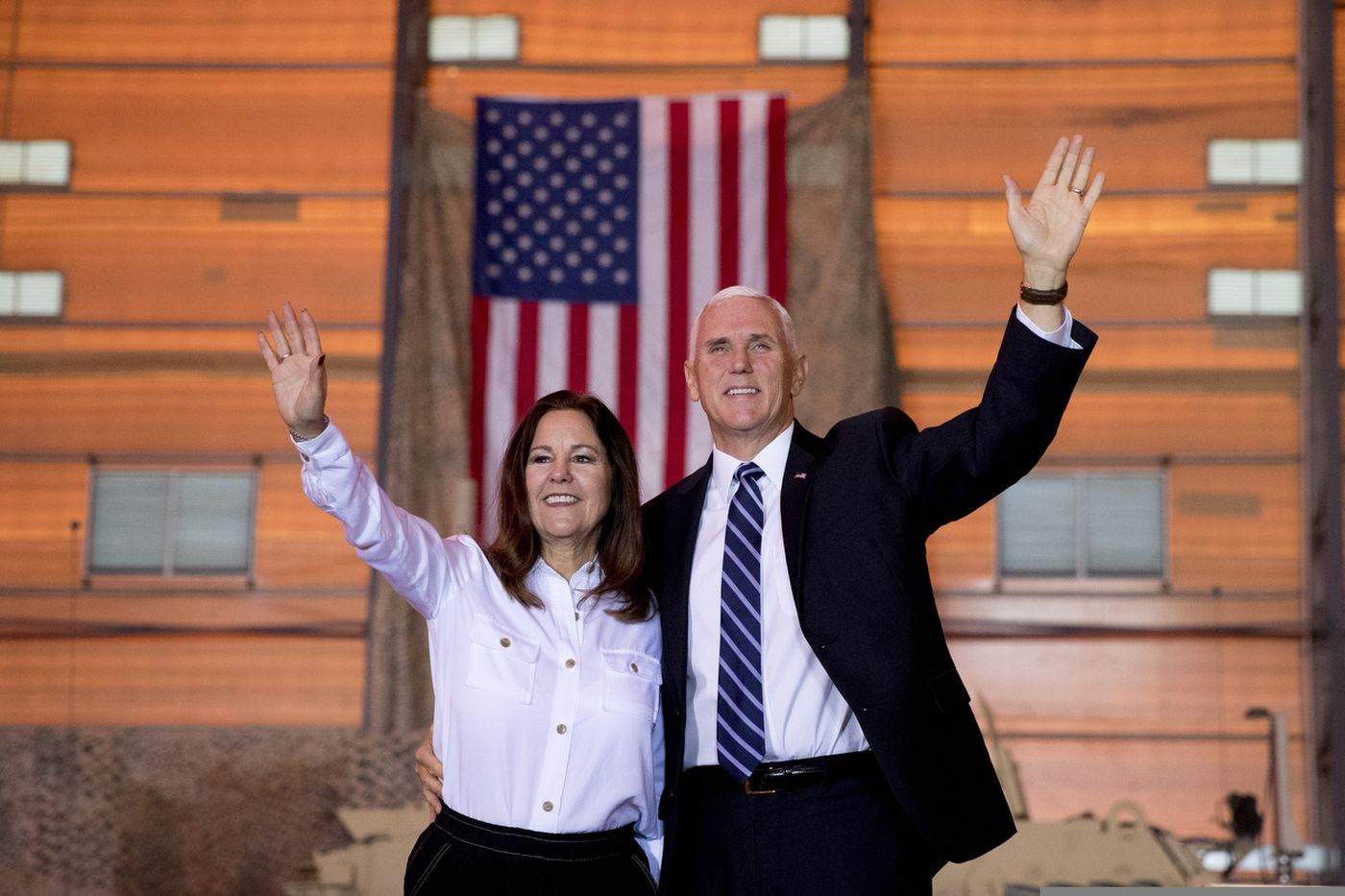 Photo: Andrew Harnik/AP. Caption: Vice President Mike Pence and his wife Karen Pence wave as they take the stage to speak to troops at Al Asad Air Base, Iraq, Saturday, Nov. 23, 2019. The visit is Pence’s first to Iraq and comes nearly one year since President Donald Trump’s surprise visit to the country. 