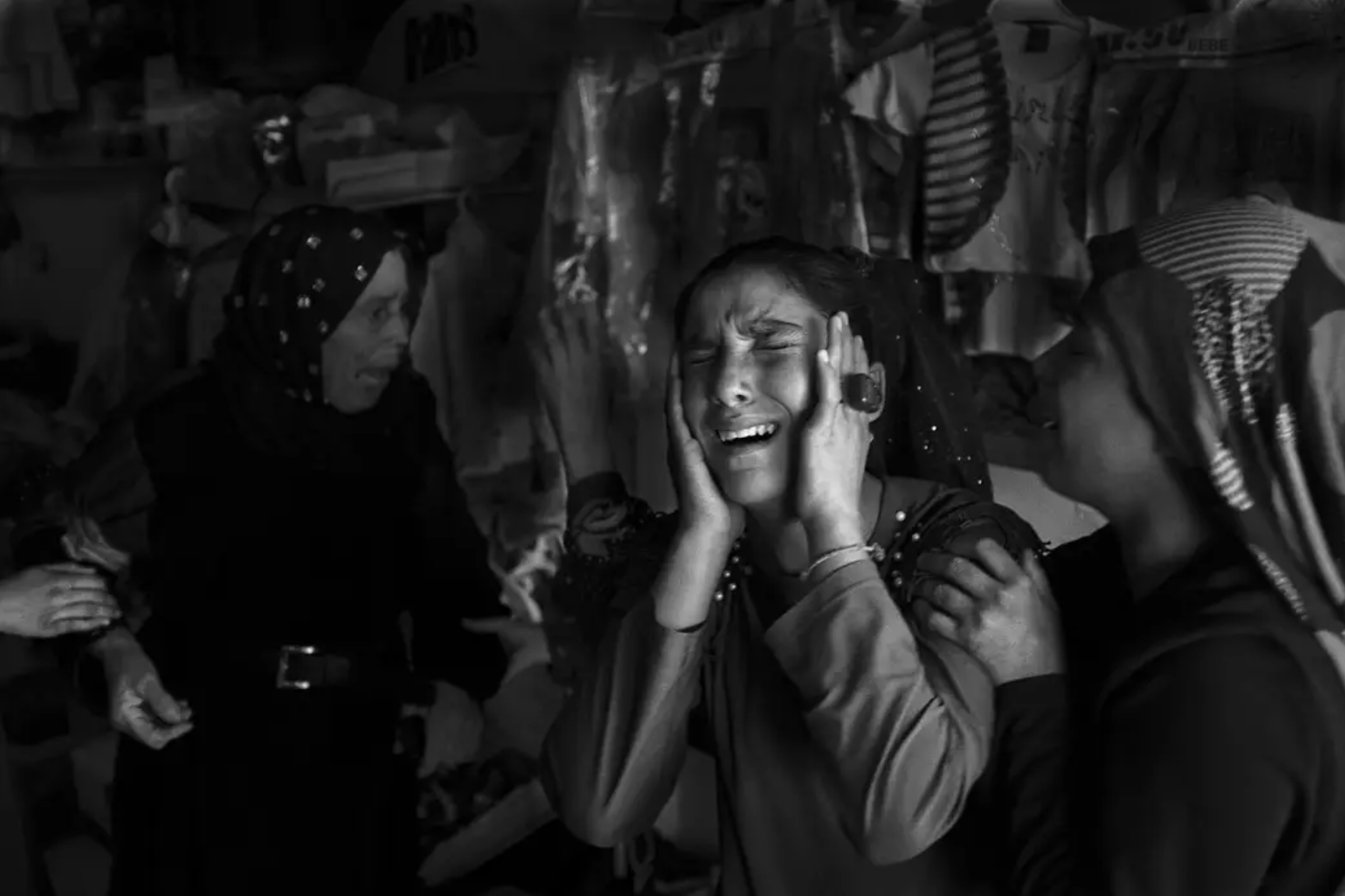 Photo: Emin Ozmen / Magnum Photos. Elif Aksoy, 13, (second from right) cries, as a mortar landed near her family's store, wounding everyone in the store, including her father, brothers, and sisters.