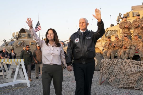 Photo: Andrew Harnik/AP. Caption: Vice President Mike Pence and his wife Karen Pence wave as they take the stage to speak to troops at Al Asad Air Base, Iraq, Saturday, Nov. 23, 2019. The visit is Pence’s first to Iraq and comes nearly one year since President Donald Trump’s surprise visit to the country.