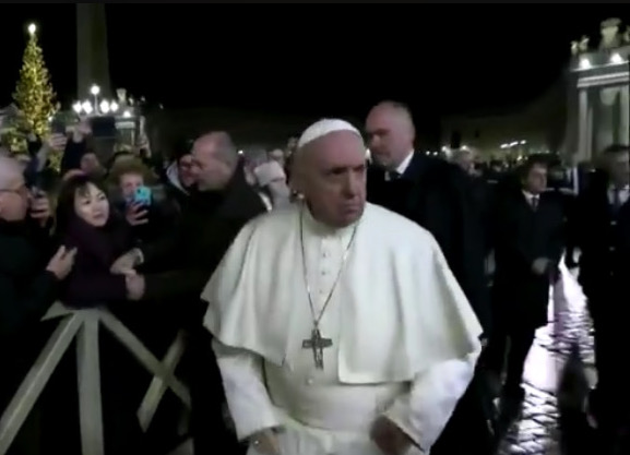 The woman clearly grabbed onto his arm and wouldn’t let go. On the other hand, she clearly pissed His Holiness off.