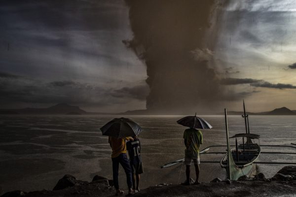 Photo: Ezra Acayan/Getty Images. Residents of Luzon island in the Philippines watch as the Taal volcano erupt on January 12. The Philippine Institute of Volcanology and Seismology has raised alert level to 3 out of 5, warning of the volcano’s continued “magmatic unrest”.