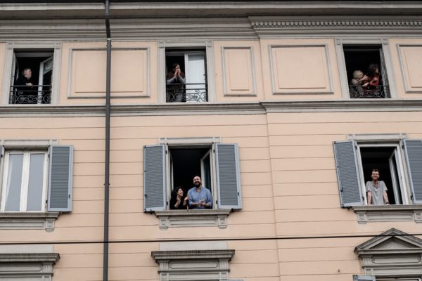 Photo: Alessandro Grassani for The New York Times Caption: Encouraging doctors and nurses from balconies in Milan, March 14, 2020.