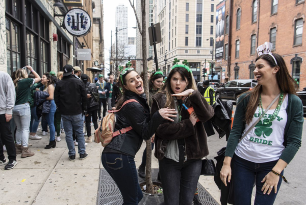 Photo: Tyler LaRiviere/Sun-Times Caption: The St. Patrick’s Day parades were canceled Saturday amid fears of the spread of coronavirus, people still flocked to River North to celebrate Saturday, March 14, 2020.