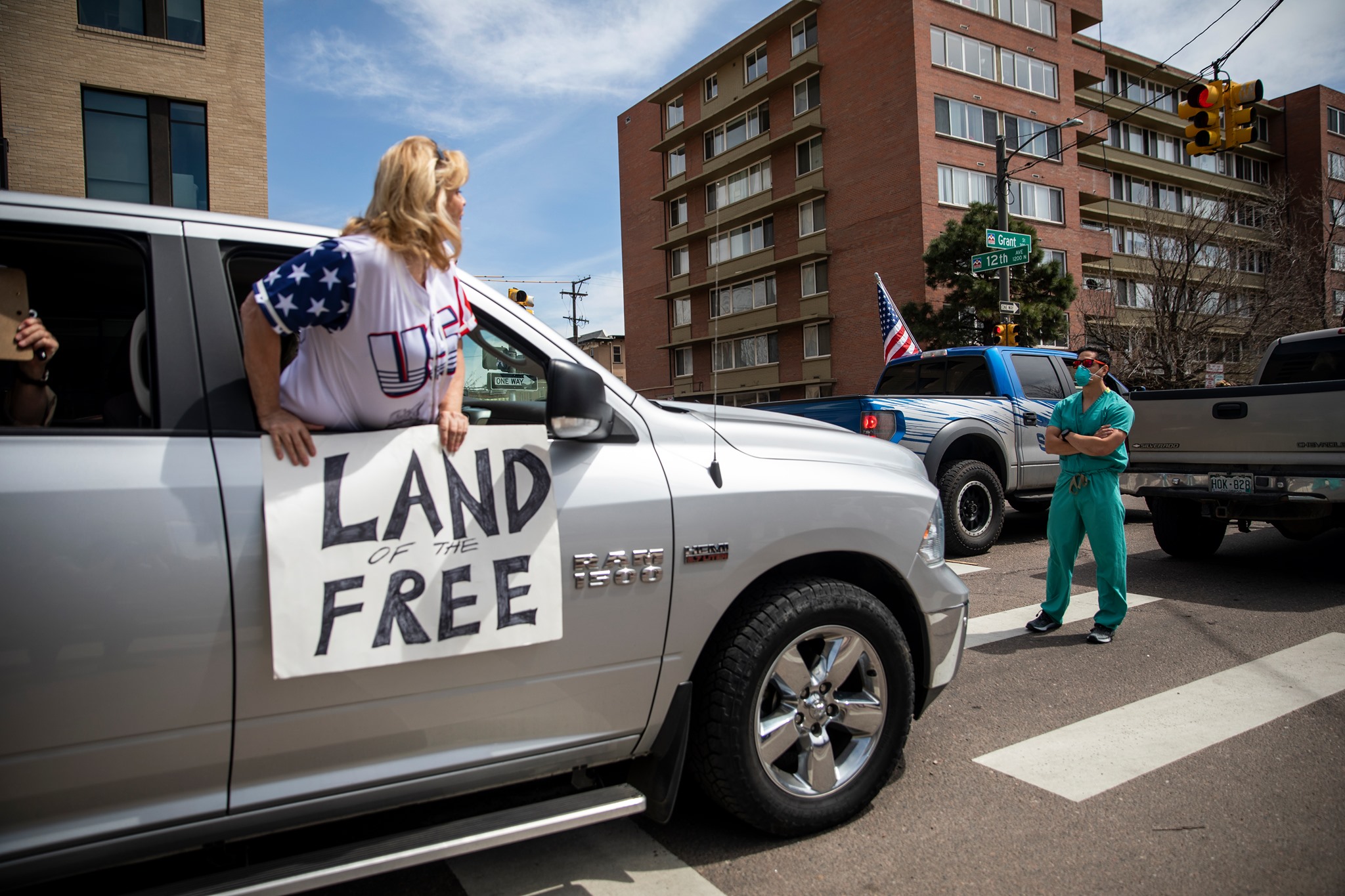 Health care workers stand in the street in counter-protest to hundreds of people who gathered at the State Capitol to demand the stay-at-home order be lifted in Denver, Colorado, April 19, 2020. Photo: Alyson McClaran