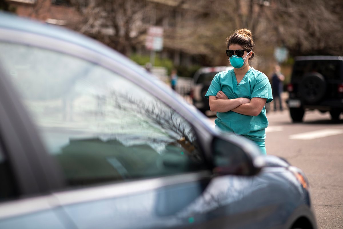 Health care workers stand in the street in counter-protest to hundreds of people who gathered at the State Capitol to demand the stay-at-home order be lifted in Denver, Colorado, April 19, 2020. Photo: Alyson McClaran