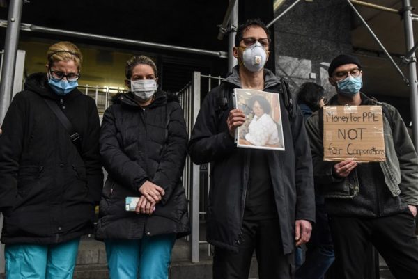 Mt. Sinai medical workers hold up photos of medical workers who have died from the coronavirus during a protest on April 3, 2020 in New York City. Medical workers are protesting the lack of personal protective equipment during a surge in coronavirus cases. (Photo by Stephanie Keith/Getty Images)