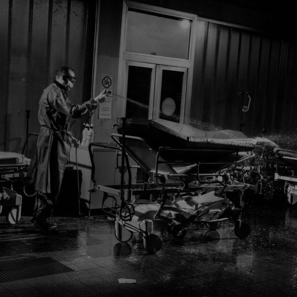 In an E.R. in the northern city of Reggio Emilia, a paramedic sprays down hospital beds. Along with Lombardy, the Emilia-Romagna region has been among the most ravaged by the pandemic. Photo by Alex Majoli/Magnum Photos