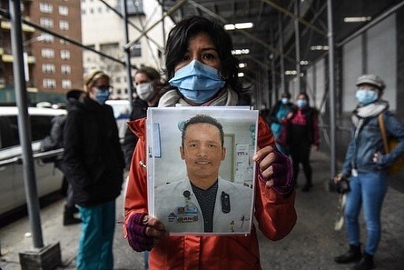 Mt. Sinai medical workers hold up photos of medical workers who have died from the coronavirus during a protest on April 3, 2020 in New York City. Medical workers are protesting the lack of personal protective equipment during a surge in coronavirus cases. (Photo by Stephanie Keith/Getty Images)