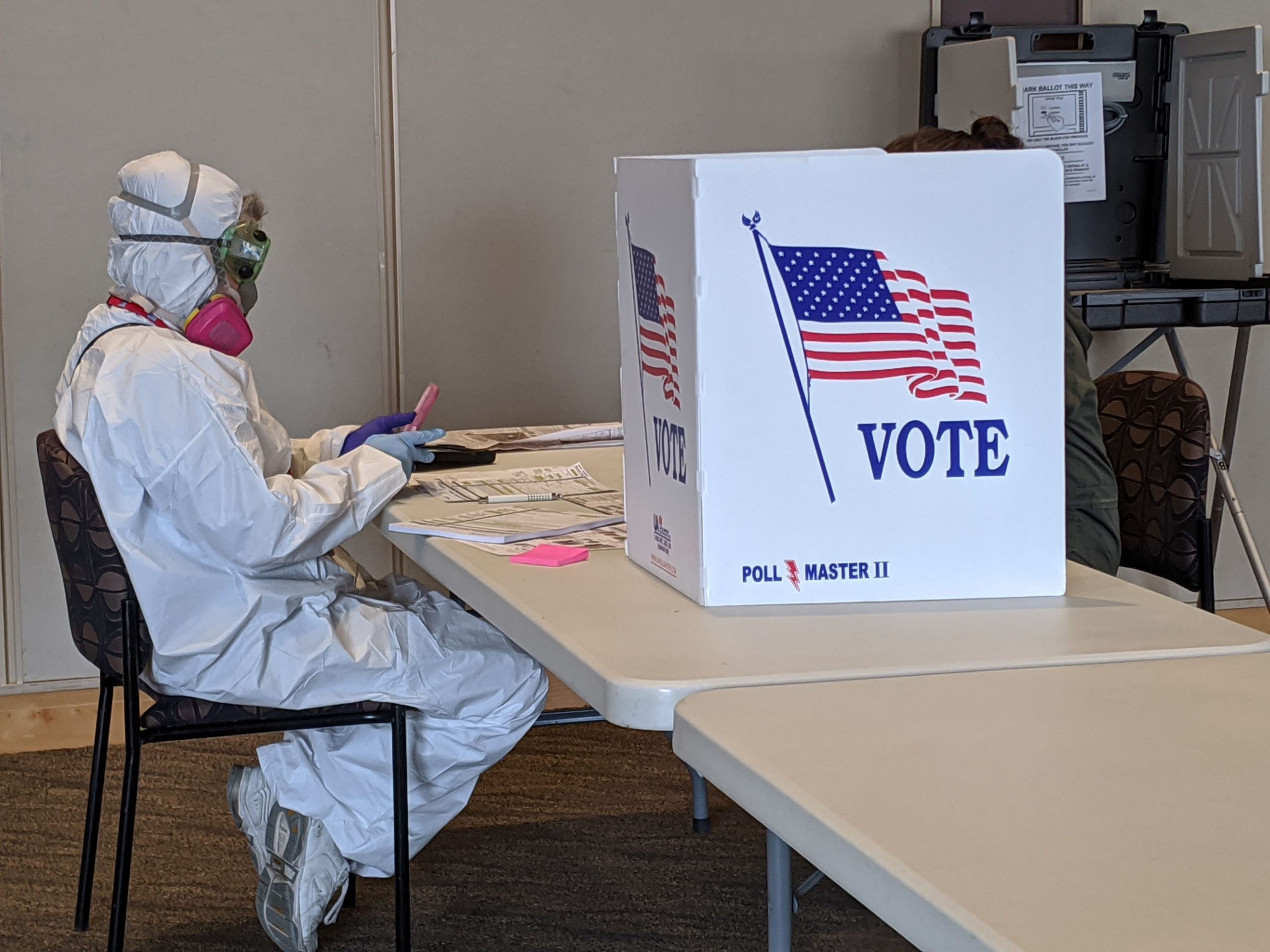 Derek R. Henkle/AFP via Getty Images Caption: Elections Chief Inspector Mary Magdalen Moser runs a polling location in Kenosha, Wisconsin, in full hazmat gear as the Wisconsin primary kicks off despite the coronavirus pandemic, on April 7.