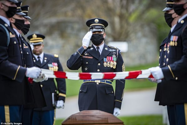 Photo: Elizabeth Fraser/U.S. Army/Arlington National Cemetery via Getty Images Caption: In this handout photo provided by the US Army/Arlington National, A soldier assigned to 1st Battalion, 3d U.S. Infantry Regiment (The Old Guard) renders honors during the funeral for U.S. Army Retired Command Sgt. Maj. Robert M. Belch in Section 68 of Arlington National Cemetery, April 14, 2020 in Arlington, Virginia. Given current health protection guidance from the Secretary of Defense, Old Guard Soldiers wear face coverings to mitigate the spread of COVID-19 while executing the Memorial Affairs mission. Command Sgt. Maj. Belch served in the Army for 26 years, where he was a Combat Engineer with the 42nd Infantry, 142nd Combat Engineer Battalion, Rainbow Division, as a decorated World War II veteran, he earned several commendations that included the Legion of Merit.