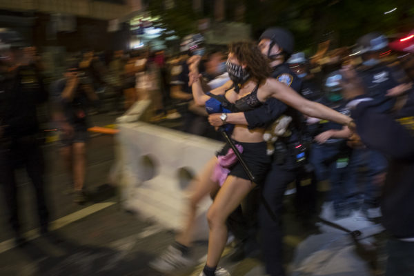 Brooklyn, New York May 30, 2020 Police arrest a protester. The killing in Minneapolis, MN of George Floyd, who was black, by a white police officer last week has touched off nationwide protests. Several hundred demonstrators and police clashed for hours on Saturday evening in the Flatbush neighborhood of Brooklyn, along Bedford and Church Avenues. At least two police cars and several garbage dumpsters were burned and dozens of pepper spray use incidents and arrests ensued. Photograph by ALAN CHIN