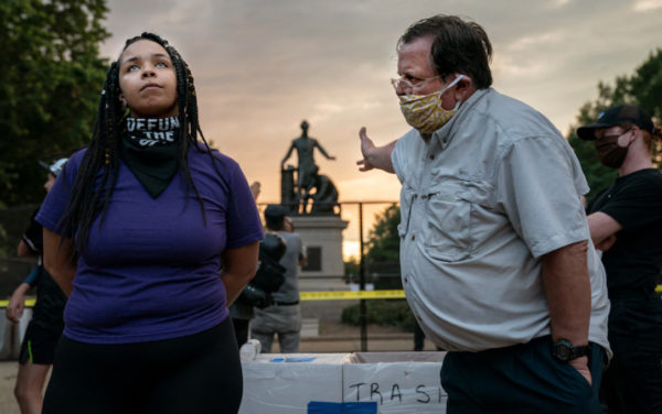 A woman who wants the Emancipation statue in Lincoln Park in the District to be removed stands Thursday beside a man who argued for keeping it. (Evelyn Hockstein for The Washington Post)