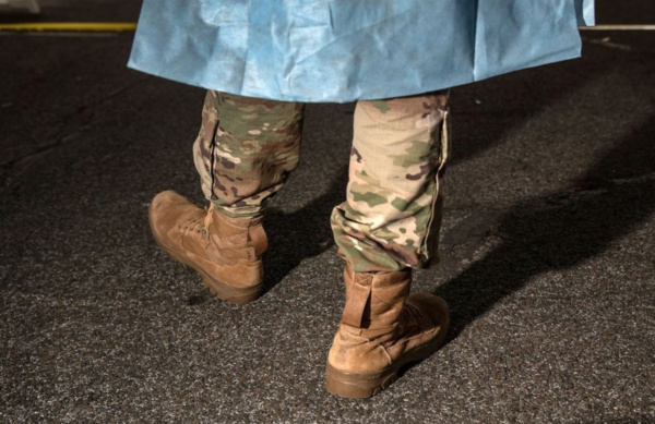 NEW YORK, NY - MARCH 28: A U.S. National Guard medic awaits patients at a drive-thru testing center at Lehman College on March 28, 2020 in the Bronx, New York City. The center, opened on March 23 at Lehman College, can test up to 500 people per day for COVID-19. (Photo by John Moore/Getty Images)