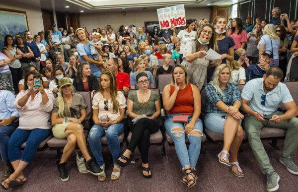 Rick Egan for The Salt Lake Tribune, Caption: Angry residents react when the Utah County Commission meeting was adjourned before it even started. The group protesting against masks being required in schools removed the social distancing tape on the chairs and filled the Utah County Commission room to over flowing, prompting Commissioner Tanner Ainge to call for a vote to adjourn the meeting in Provo, on Wednesday, July 15, 2020