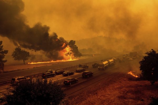 Noah Berger/AP. Flames from the  LNU Lightning Complex fires jump Interstate 80 in Vacaville, Calif., Wednesday, Aug. 19, 2020. The highway was closed in both directions shortly afterward. Fire crews across the region scrambled to contain dozens of wildfires sparked by lightning strikes as a statewide heatwave continues. ⠀