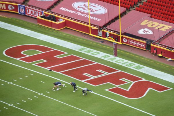 Members of the Houston Texans stretch near a social justice sign in the end zone prior to their NFL football game against the Kansas City Chiefs, Thursday, Sept. 10, 2020, in Kansas City, Mo. (AP Photo/Reed Hoffmann) Reed Hoffmann/Associated Press