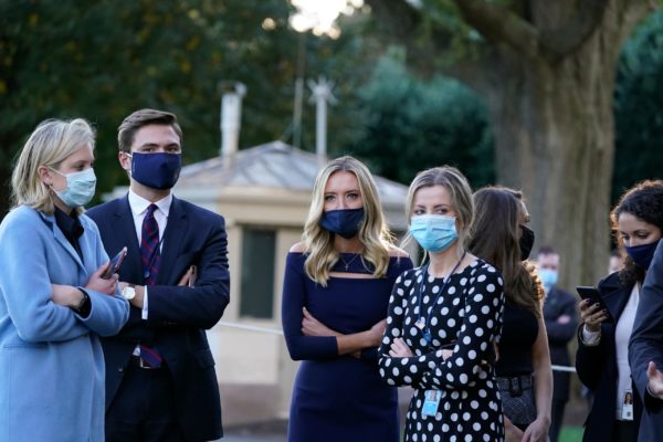 PHOTO: ALEX BRANDON, AP White House press secretary Kayleigh McEnany, third from left, waits with others as President Donald Trump prepares to leave the White House to go to Walter Reed National Military Medical Center after he tested positive for COVID-19, Friday, Oct. 2, 2020, in Washington.
