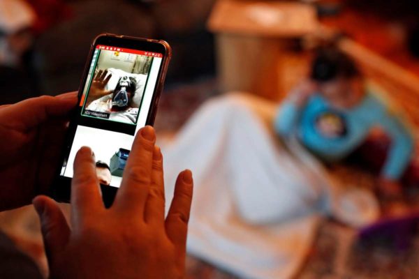 Verónica Hernández, looks at an image from a family call on Zoom of her uncle, José Jesús Arroyo, as he waves goodbye to his family before losing his life to COVID-19 earlier this month. Photographed at the Hernández home in Santa Rosa, Calif., on Thursday, December 17, 2020.Photo: Scott Strazzante / The Chronicle