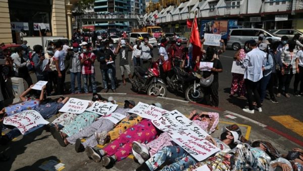 People display placards as they rally against the military coup