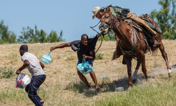 A United States Border Patrol agent on horseback tries to stop a Haitian migrant from entering an encampment on the banks of the Rio Grande near the Acuna Del Rio International Bridge in Del Rio, Texas on September 19, 2021. - The United States said Saturday it would ramp up deportation flights for thousands of migrants who flooded into the Texas border city of Del Rio, as authorities scramble to alleviate a burgeoning crisis for President Joe Biden's administration. (Photo by PAUL RATJE/AFP via Getty Images)