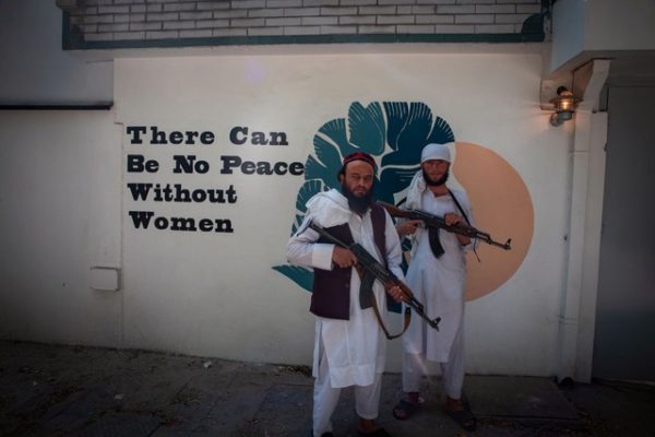 The message on the wall is inconsistent with the Taliban's rule the last time they were in power.