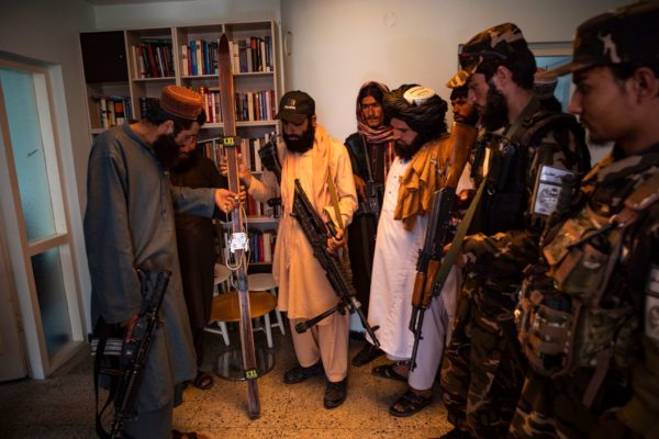 Taliban soldiers examine wooden skis,