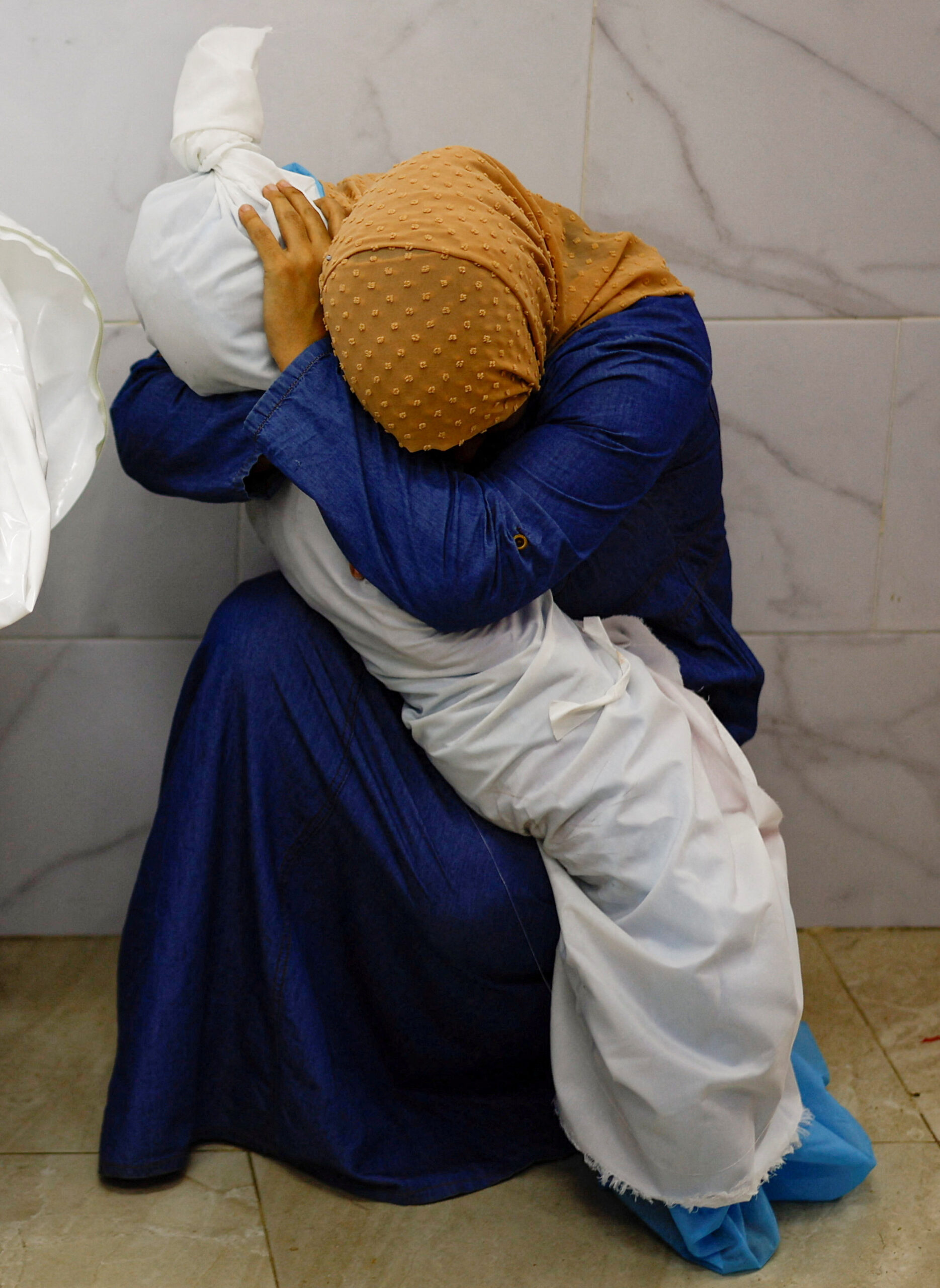 Chatting the Pictures: Mourning Embrace in a Gaza Hospital
